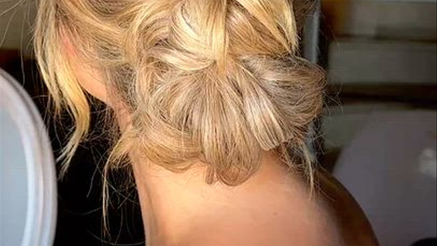 Low messy bun and soft natural makeup